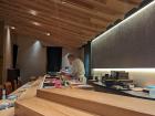 In this omakase restaurant, you can see a chef preparing some fish!