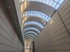 One of the outside halls of Tokyo Opera City Tower with a round dome on the top, preventing rain from coming through but providing ample sunlight into the hall below!