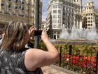 My grandma taking a photo of the same fountain that I introduced previously that is located in the city center!