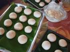 After letting the dough rise, we placed the bread rolls on trays lined with banana leaves and baked them for just 15 minutes