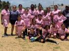 The female football team for St. Francis Xavier poses after receiving new uniforms