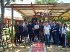 Students and volunteers working on a gardening and recycled art project