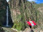 Waving the Peruvian flag in front of a waterfall