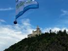 Michael: The RTW Travel Club flag flying beneath a beautiful hillside castle