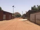 This is a typical street view of my town. All roads are dirt and sandy. You'll notice we do have solar powered streetlamps which also power a faucet system throughout the town for clean drinking water. 