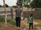 My husband practices "Roondagol" (carrying items on his head) while our host brother Abouli watches. 