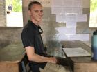 My husband Usumon (Matthew) sits at a desk in our Pulaar class. Students typically sit two or three to a desk when school is in session.