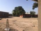 The elementary, middle and high schools in my town are built similarly with groups of buildings in an enclosed cement-fenced area and an open area with a few trees for outdoor activities. 