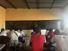 Usumon Gako, an English teacher, writes a lesson on the board for his most advanced English class. These students have been taking English for seven years now. 