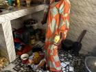 My host mom prepares lunch during a holiday for a large crowd. She's already dressed up nicely now to put the food out.