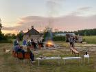 Emma hanging out with friends at a bonfire, much like we would in America