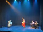 Two "flamenco" dancers using fans as part of their dance