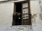 A cat taking a nap, perched on a window in Granada