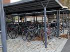 Bike parking outside a university dorm with roof to protect bikes from rain and snow