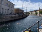 A swimming competition happening in the city canal