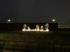 Image of trees made of light on the walls of a train station