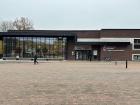 Large windows and long benches in front of a library