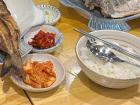 An example of side dishes served with fish: Kimchi (in red) and a bowl of rice