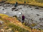 Me walking through a river at the Hornstrandir Nature Reserve in the Westfjords of Iceland