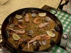 A seafood paella in a paellera (paella dish) that serves four people 