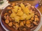 A traditional octopus and potato dish (pulpo a la gallega) seasoned with paprika and sometimes olive oil