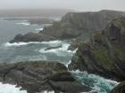 The Ring of Kerry is a road that wraps around the Iveragh Peninsula, known for its scenic landscapes, including the Cliffs of Kerry