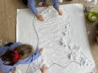 Kids fill in a big drawing of a ghost