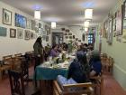 Peruvian guest giving short speech at a long Thanksgiving table