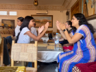 A candid moment between a host sister and one of my peers as they play a hand game. 