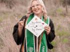 Standing in my black gown and green stole to celebration my graduation from Colorado State University! 