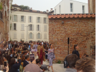Outdoor runway show with enthusiastic crowd
