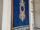 Tapestry on the wall with the phrase "Justice" written on it