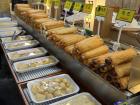 A street food stall selling different snacks wrapped in fried fish cakes