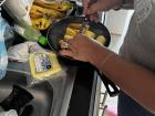 Ruth preparing the fried plantains