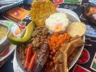 "Bandeja paisa," a heavy meal that usually has rice, beans, "morcilla" (blood sausage), a slice of avocado, plantain, "chicharrones" (fried pork belly) or beef, an "arepa" and a fried egg