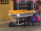 A man wading through a flooded Cartagena to sell mangos