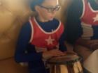 My cousin wearing the Cuban flag and playing the bongos.