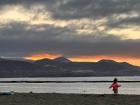 A little girl dancing on the beach at sunset