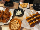 Korean 치킨 (chicken), or fried chicken, and 소떡소떡 (sotteok-sotteok), a street food of sausage and rice cakes