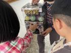 Students get fake money when they accomplish something, and they can use the money to buy toys from a fake vending machine at school!