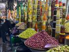 Like the tilework of the Fes workshops, the souks (markets) of Marrakech are filled with stands that glisten with colorful olives and fruit 