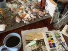 I enjoy painting and drinking coffee at my desk, which I decorate with local shells!