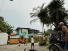My host brothers playing basketball together on a cloudy day