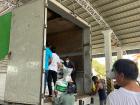 My coworkers helping unload an arrival of seeds for local farmers