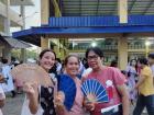 Showing off fans with my neighbors at a friend's graduation