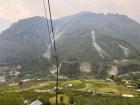 This is a view of the farms at the bottom of Tachai village. All the village homes are higher up the mountain. Some people have farms in town and some people have farms down here. On the mountains, you can see the marks of previous landslides