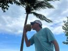 My dad enjoying a coconut on the beach