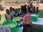 Rice and chicken being served as a special dish to children at this year's Church Christmas party (notice how there are no utensils)