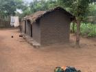 Typical Malawian home with the maize, bucket for washing, and line for drying