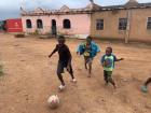 Kids playing football with a homemade ball: a normal balloon wrapped with multiple plastic bags/cloth followed by twine to hold it all together!